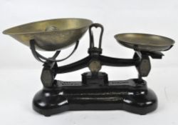 A set of black Libra Scale Co. weighing scales with brass dishes and weights