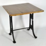 A vintage pine topped table mounted on cast metal base, patent no 2412,