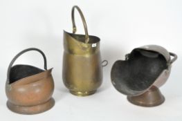 A group of three brass and copper coal scutles,