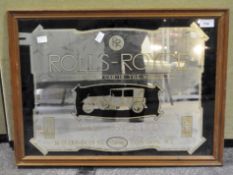 A vintage Rolls Royce advertising mirror in black and gold