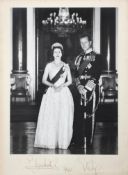 A signed black and white photograph of Elizabeth II and Prince Phillip, dated 1961,