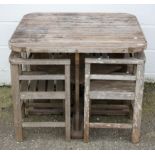 A Heals wooden garden table and four chairs, of slatted construction and square section,