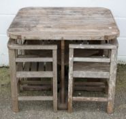 A Heals wooden garden table and four chairs, of slatted construction and square section,