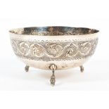 A Continental silver bowl, the borders decorated with foliate scrolls, raised upon three feet,