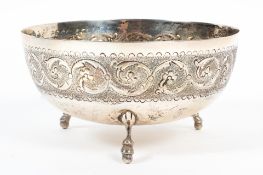 A Continental silver bowl, the borders decorated with foliate scrolls, raised upon three feet,