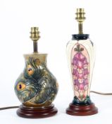 Two modern Moorcroft lamp bases, the first of squat baluster form with peacock pattern,