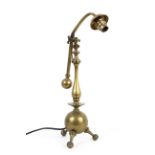 A brass adjustable desk lamp in the style of WAS Benson, early 20th century,