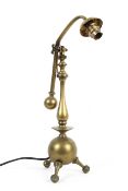 A brass adjustable desk lamp in the style of WAS Benson, early 20th century,