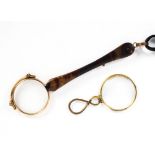 A pair of yellow metal framed lunettes and a single lens example.