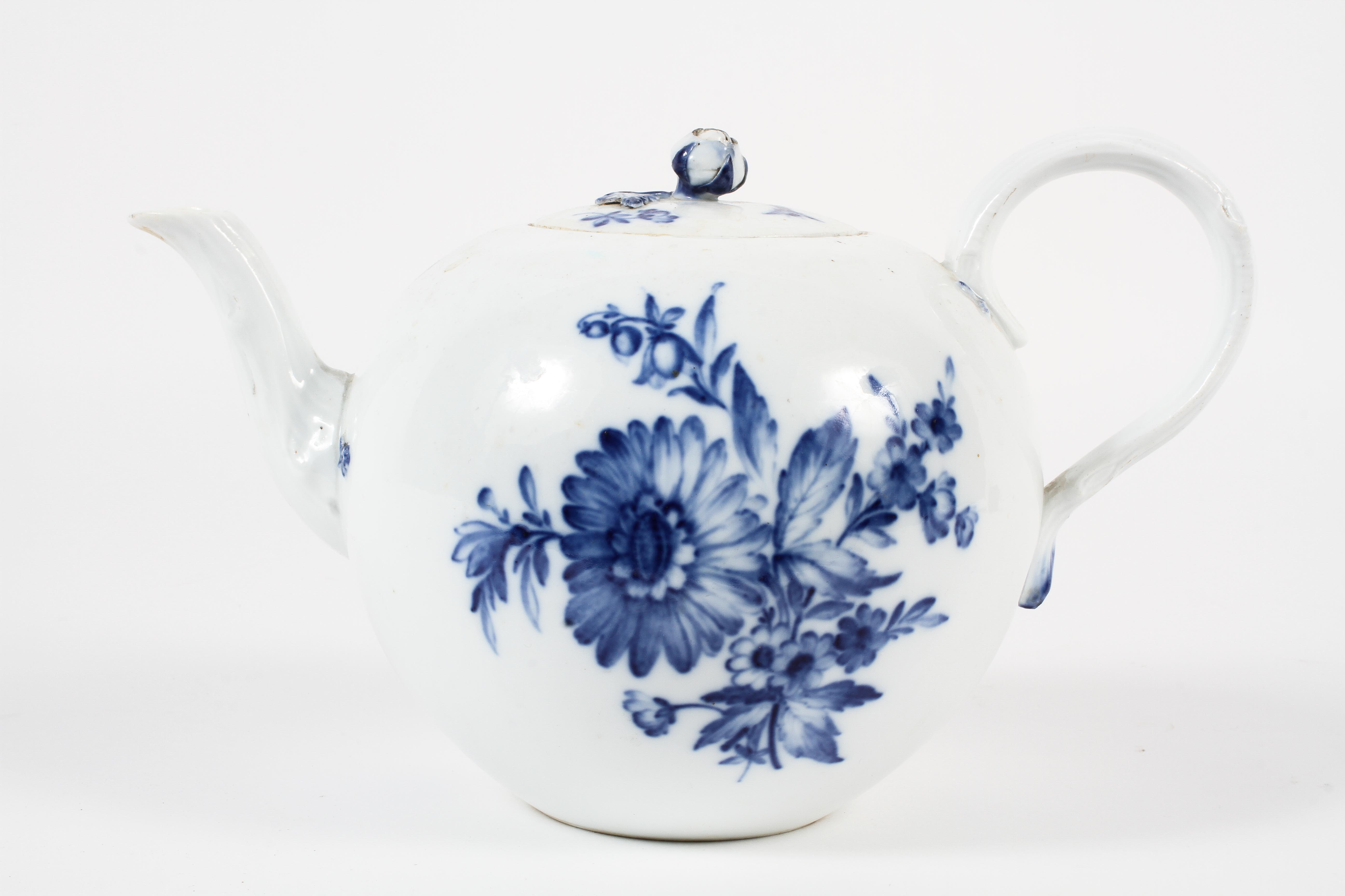A Meissen teapot and a cover, mid-19th century, blue crossed swords marks painted 63.