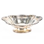 A George V silver dish, the flowing border with pierced and engraved ribbon decoration,