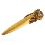 An Art Nouveau brass paper knife, circa 1900, the handle formed as a stylised dragonfly,