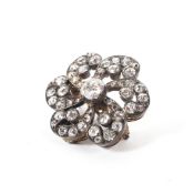An unmarked yellow and white metal diamond flower brooch set throughout with old cut diamonds. 4.9g.