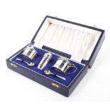 A mid-century three piece silver condiment set, comprising lidded mustard,