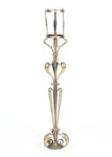 A Victorian brass ornate standard lamp in the style of WAS Benson of foliate scroll form,