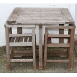 A Heals wooden garden table and two chairs, of slatted construction and square section,