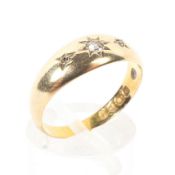An 18ct gold and diamond gypsy ring, star set with three single cut diamonds, size O