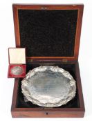 A Victorian silver salver in box together with a silver-plated presentation medal,