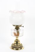 An Edwardian brass mounted oil lamp, the burner marked for Wright & Butler, Birmingham,