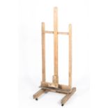 A vintage wooden artist's easel, with adjustable frame, on casters,