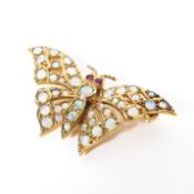 A 9ct gold and opal butterfly brooch profusely set with round cut opal cabochons