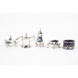 A selection of silver condiments including two open salts, two lidded mustard pots and a pepper pot