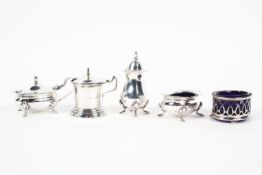 A selection of silver condiments including two open salts, two lidded mustard pots and a pepper pot