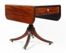 A Georgian mahogany drop-leaf table, early 19th century, with frieze drawer and dummy drawer,