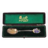 A silver and enamelled spoon given to a Harrods shareholder at a General Meeting,