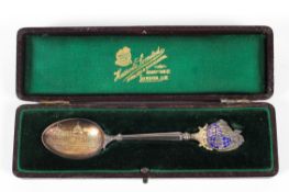 A silver and enamelled spoon given to a Harrods shareholder at a General Meeting,