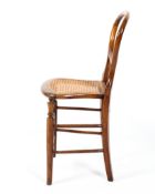 A 19th century mahogany and oak caned child's chair, with balloon back,