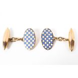 A pair of 9ct gold and enamel bullet backed oval cuff links. 4g.
