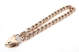 A gold curb link bracelet with heart locket both stamped 10. 14g.