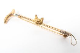 A 9ct gold fox head and whip bar brooch. 3.8g.