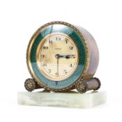 A Zenith (Swiss) alarm clock on onyx base, the gilt-metal dial with Arabic numerals,