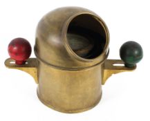 A vintage brass ships binnacle compass, the water-filled dial flanked by two coloured balls,