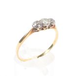 An unmarked yellow metal three stone diamond ring, Size R