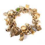 A 9ct rose gold fancy link charm bracelet set with numerous 9ct gold and yellow metal charms.