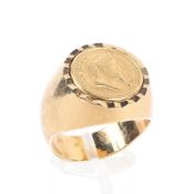 An unmarked yellow metal gentleman's coin signet ring set with Napoleon III 20 Franc coin.