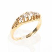 An 18ct gold and diamond five stone ring set with graduated line of old brilliant cut diamonds.