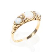 An 18ct gold opal and diamond ring set with three oval cabochon opals with old cut diamond accents.