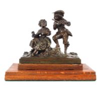 A bronze group of a flautist and companion, seated on rocky ground base,