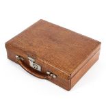 An early 20th century crocodile skin stationery case, tooled with the initials E.B.L.