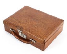 An early 20th century crocodile skin stationery case, tooled with the initials E.B.L.
