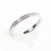 An 18ct white gold and diamond full eternity ring, chanel set line of single cut diamonds, Size J,