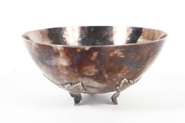 A sterling silver planished bowl of circular form raised on three cast leaf supports by AEG