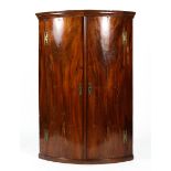 A large Georgian mahogany corner cabinet, d-shaped,