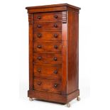 A Victorian mahogany Wellington chest, with eight graduated drawers and carved column supports,