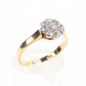 An 18ct gold and platinum diamond flower ring.