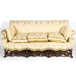 A Caroleon style upholstered three-seater sofa, in cream damask fabric with fringed tassles,